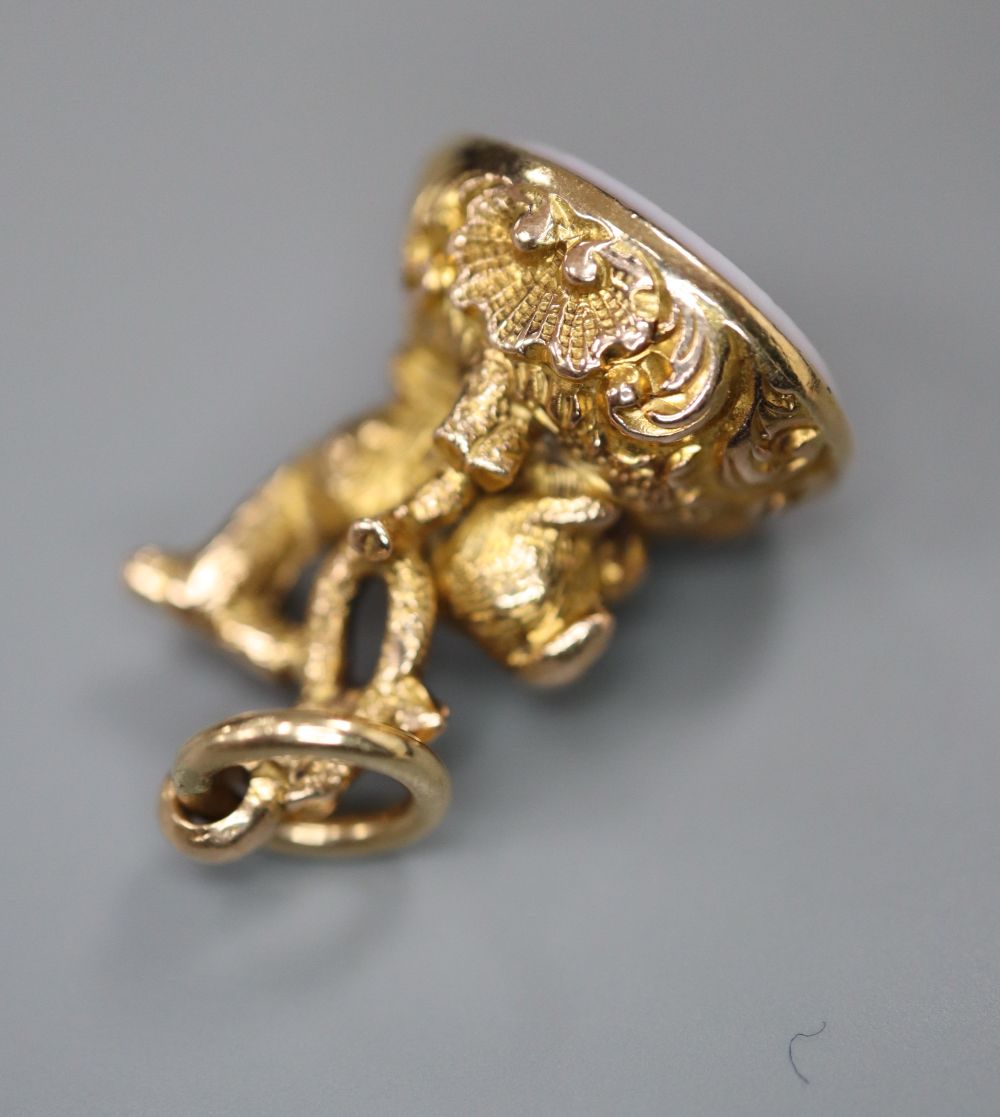 A 19th century gold (tests as 14ct) seal in the form of a recumbent deer, with intaglio-carved agate matrix, 19mm, gross 4 grams.